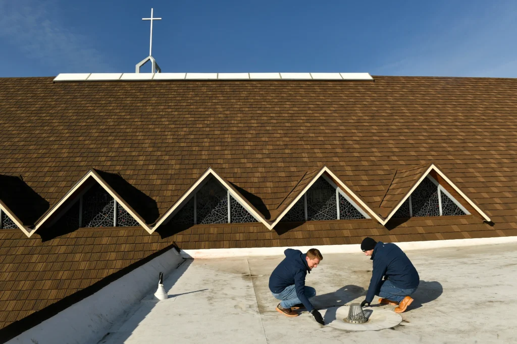 Professional contractors replacing an old residential roof with durable new roofing materials.