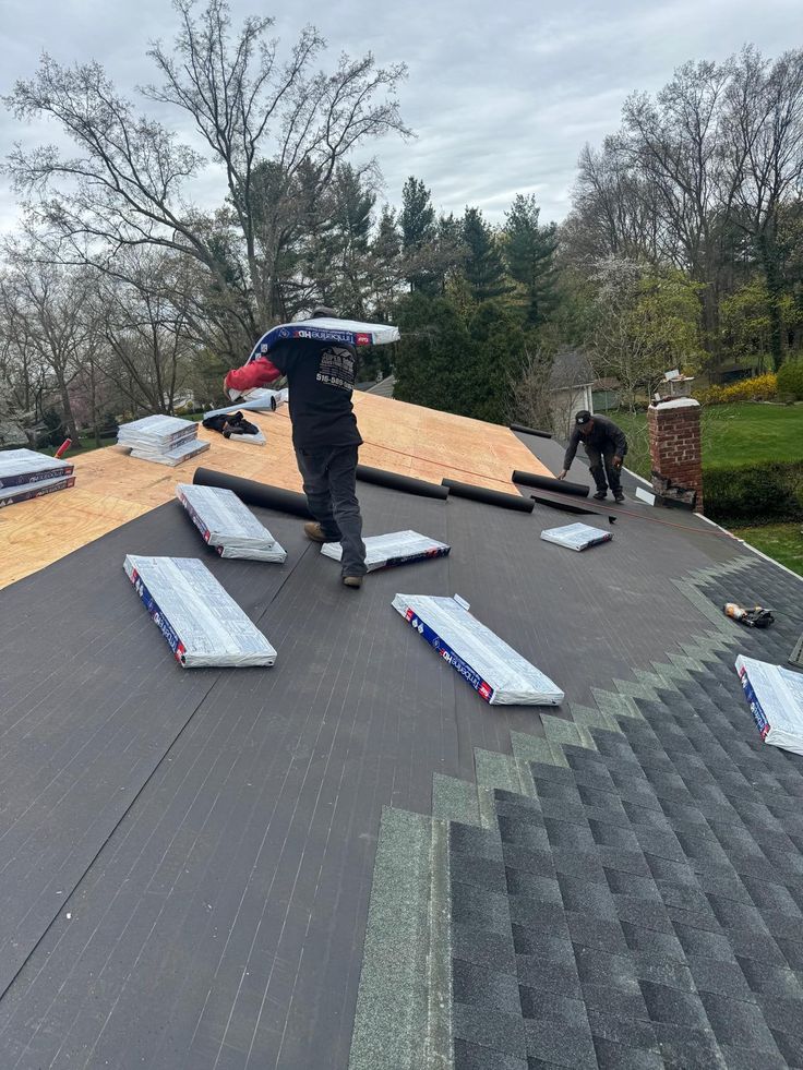 Professional roofing repair service repairing damaged residential roof in Hollywood.