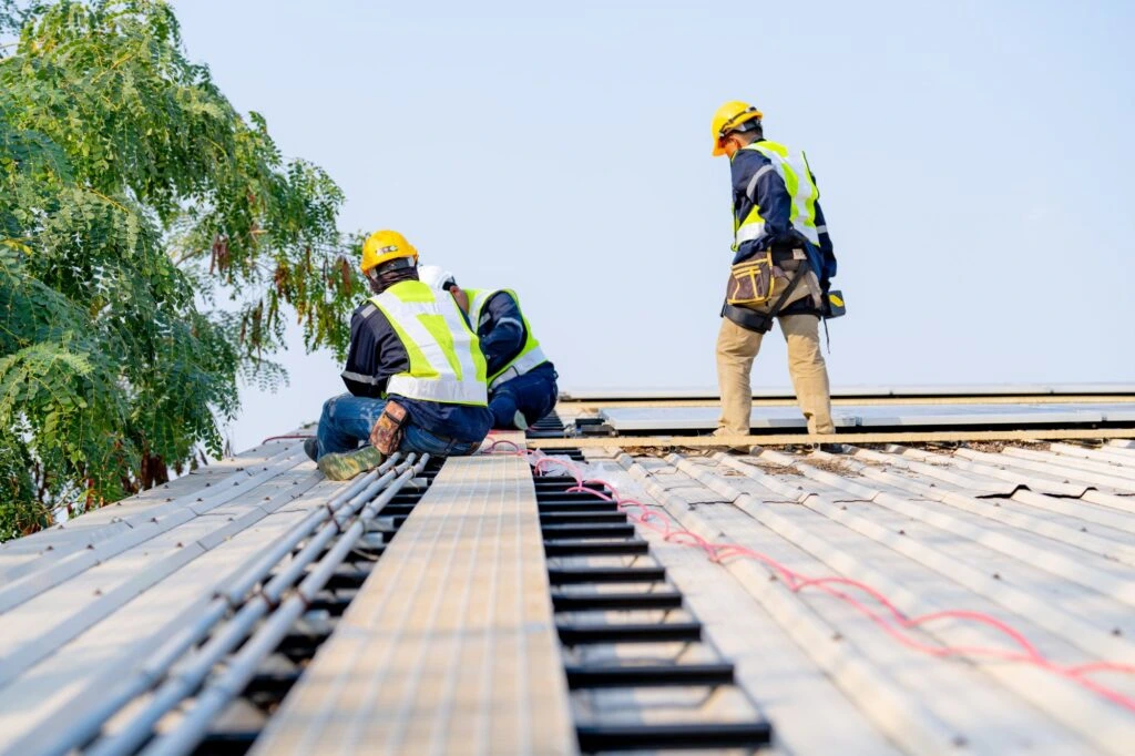 Professional roof contractor installing a new shingle roof on a home in West Hills with modern roofing tools and safety equipment.