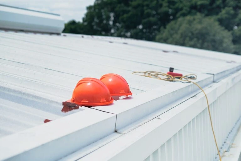 Professional roof repair contractors repairing a damaged shingle roof in Aventura, Florida using advanced tools and safety equipment.