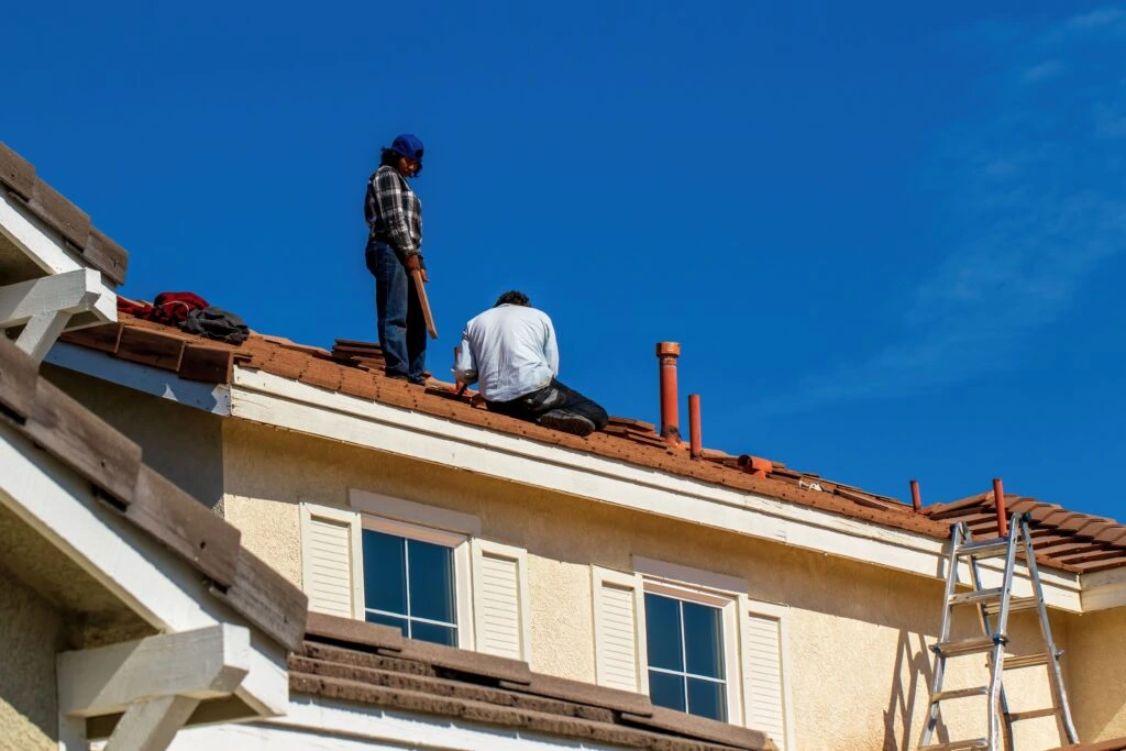 Professional roofing contractor inspecting and maintaining a residential roof to prevent damage and extend its lifespan.
