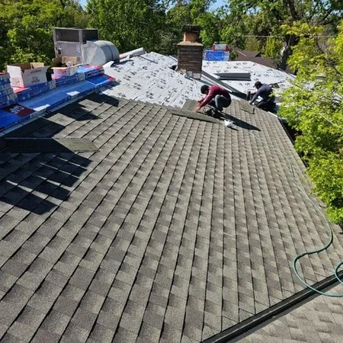 Modern home with a durable asphalt shingle roof installed by professional roofing contractors.